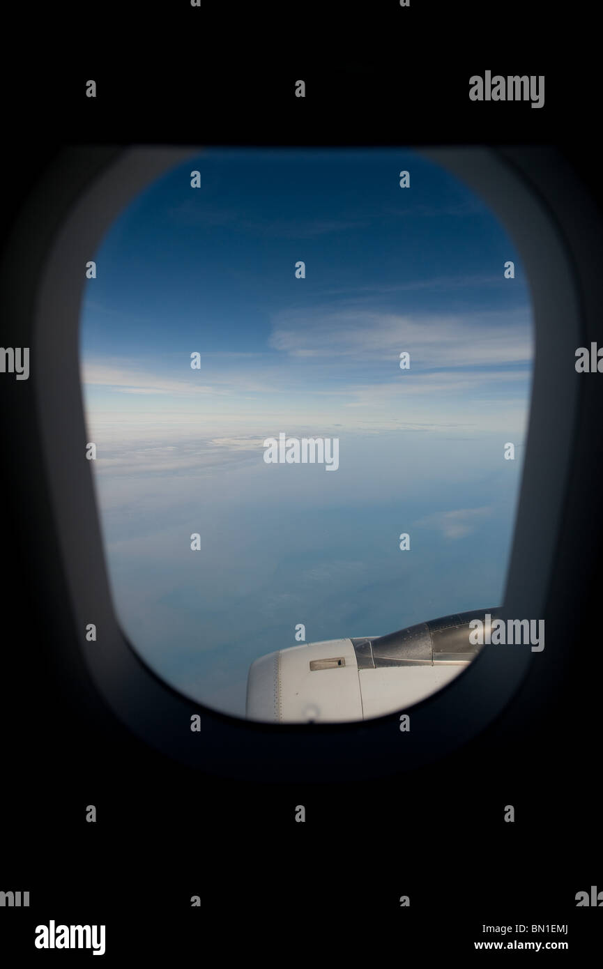 The view through the window of a commercial airliner showing blue sky ...