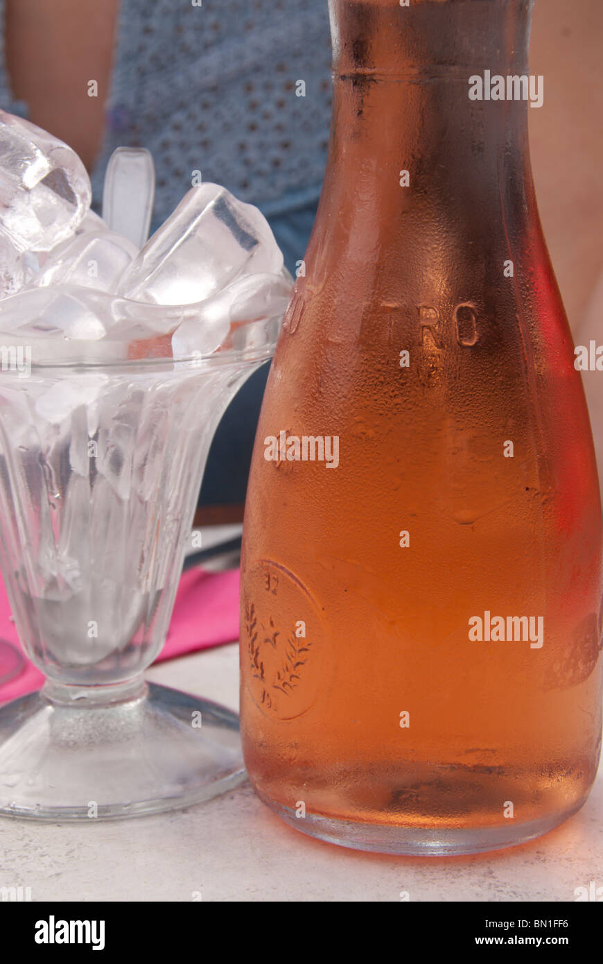 A carafe of rose wine and a glass of ice cubes at a cafe in Montpellier, Southern France. Stock Photo