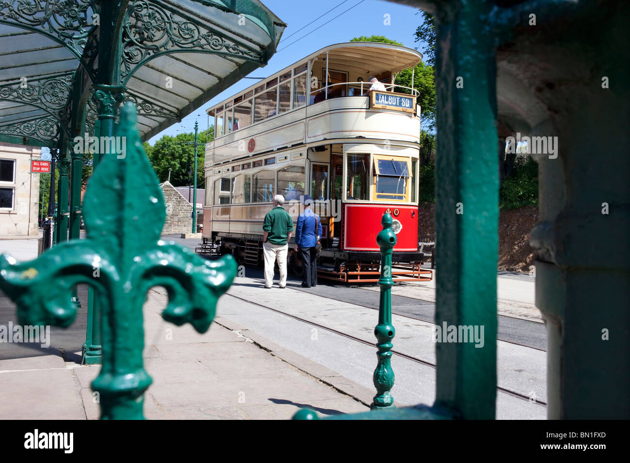 Tourists board a tram in front of the old Derby Assembly Rooms building at Crich Tramway Museum in the Peak District Stock Photo