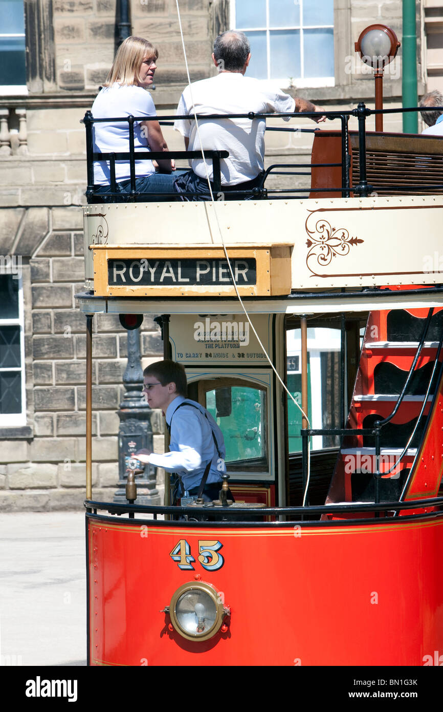 Tourists board a tram in front of the old Derby Assembly Rooms building at Crich Tramway Museum in the Peak District Stock Photo