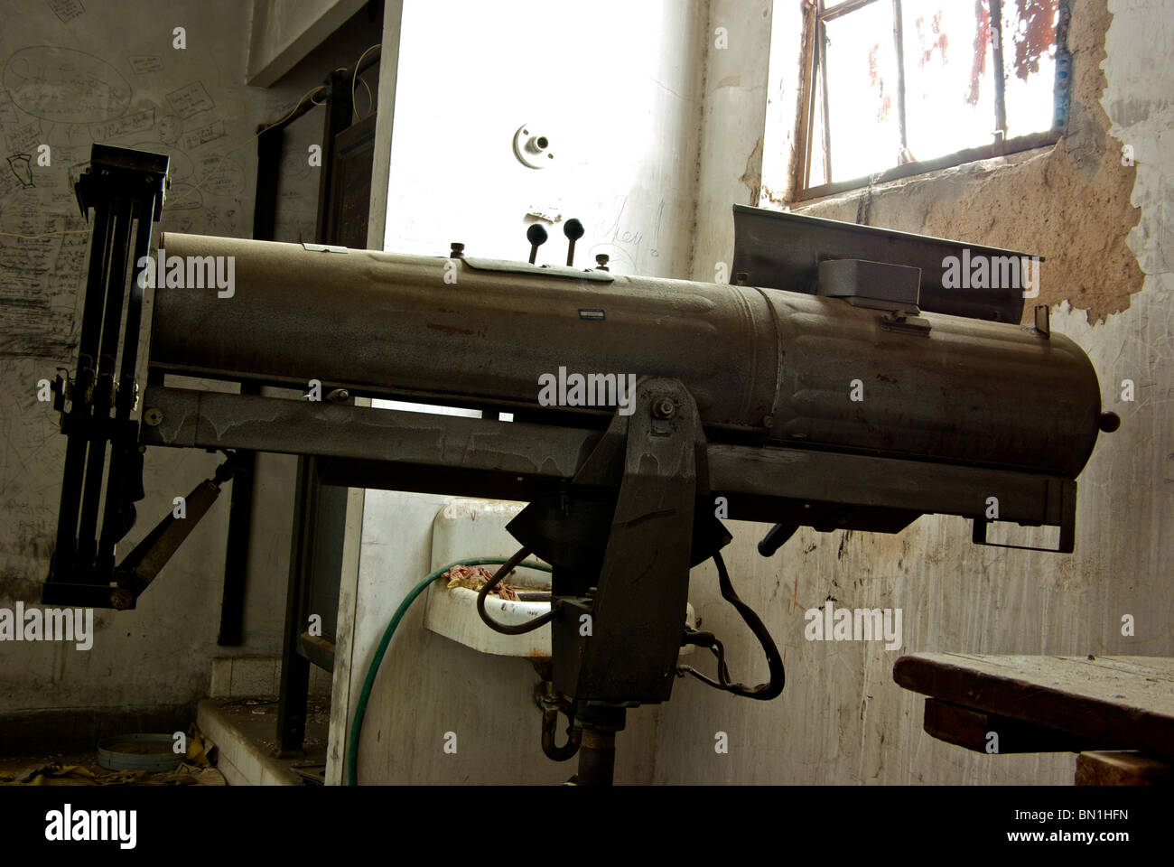 Old spotlight in grafitti covered attic projection booth of Municipal Memorial Auditorium in Shreveport LA Stock Photo