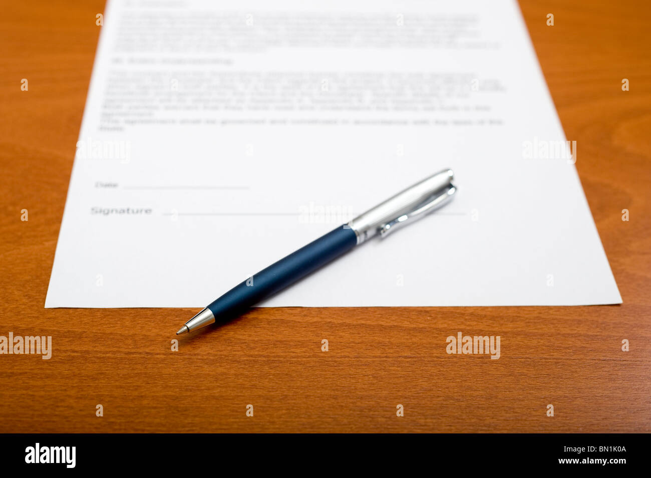 pen and a blank contract on a table, ready to be signed Stock Photo