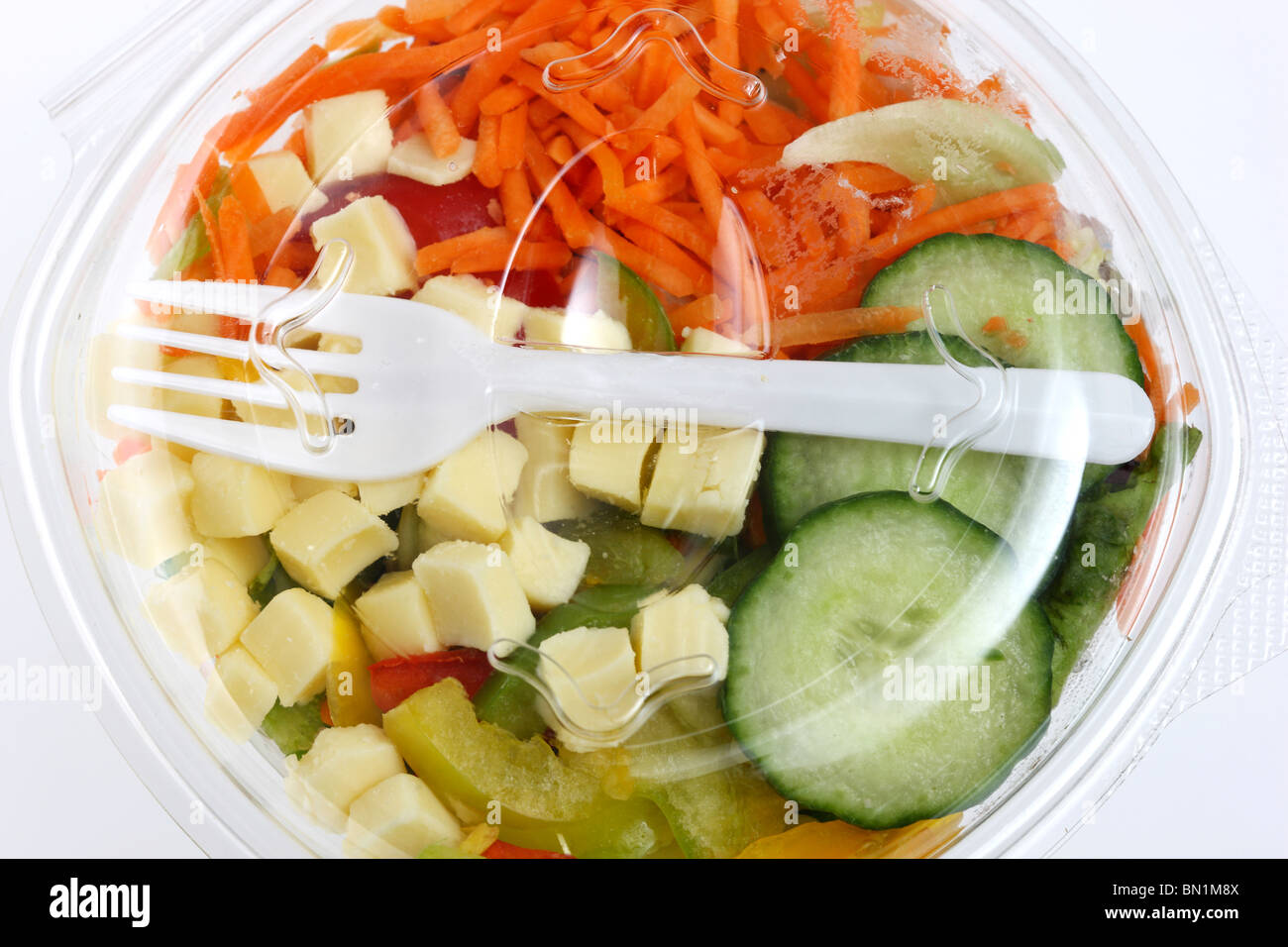 Packed, fresh prepared salads in a plastic box, from a cooler in a