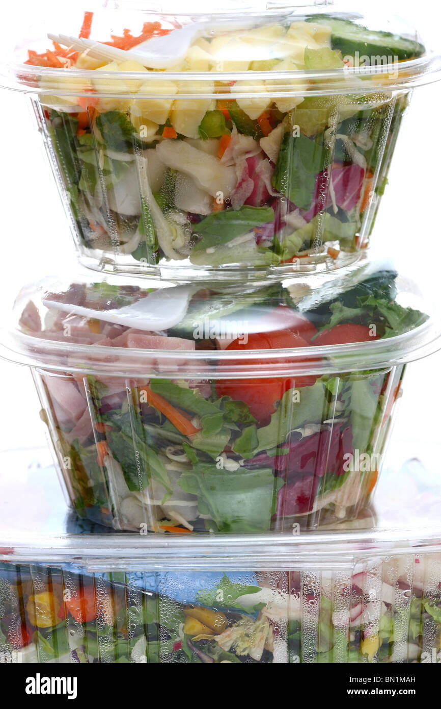 Packed, fresh prepared salads in a plastic box, from a cooler in a