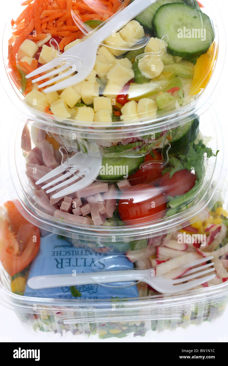 Packed, fresh prepared salads in a plastic box, from a cooler in a