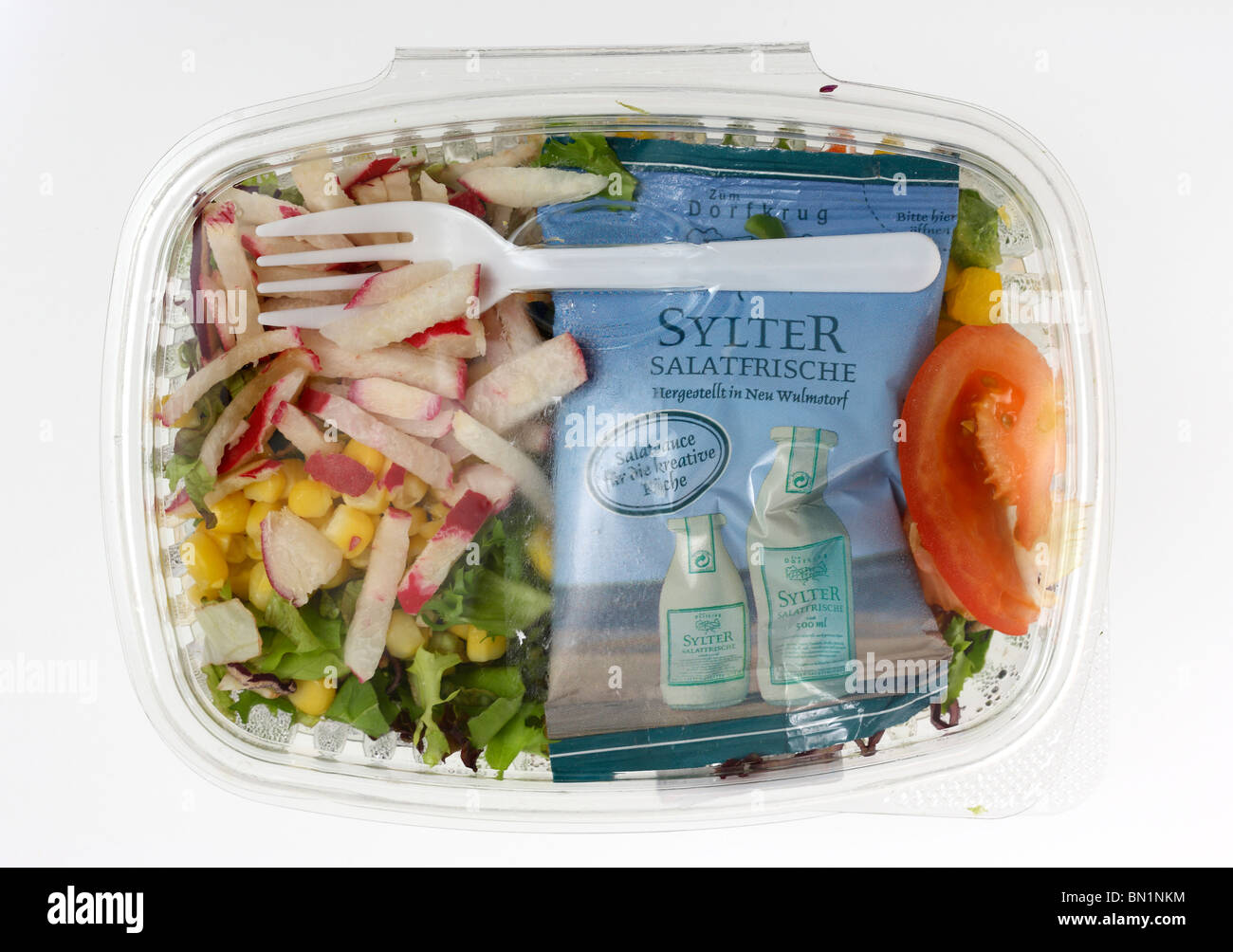 Packed, fresh prepared salads in a plastic box, from a cooler in a