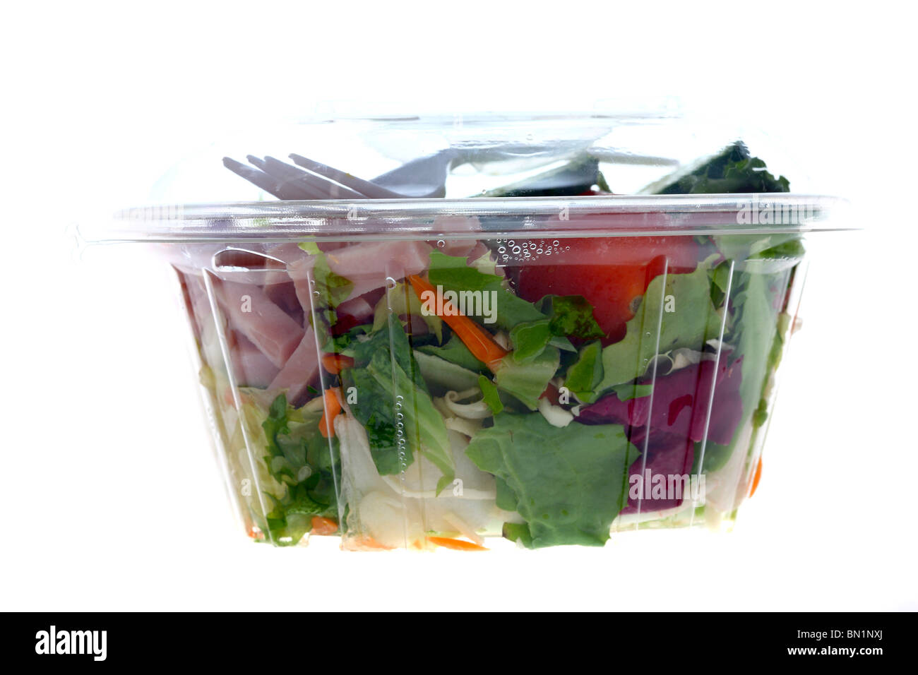 Packed, fresh prepared salads in a plastic box, from a cooler in a