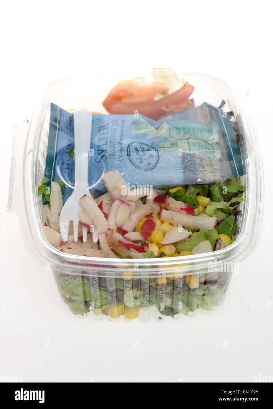 Packed, fresh prepared salads in a plastic box, from a cooler in a
