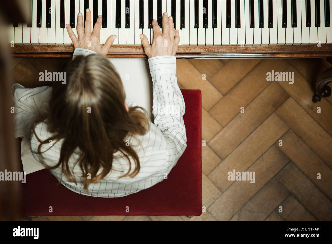 Woman playing piano Stock Photo