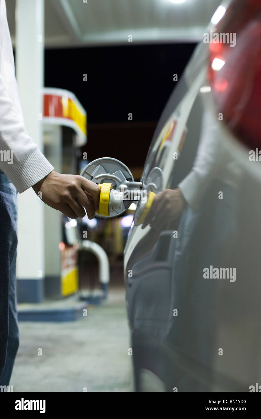 Driver opening gas tank to refuel at gas station Stock Photo Alamy