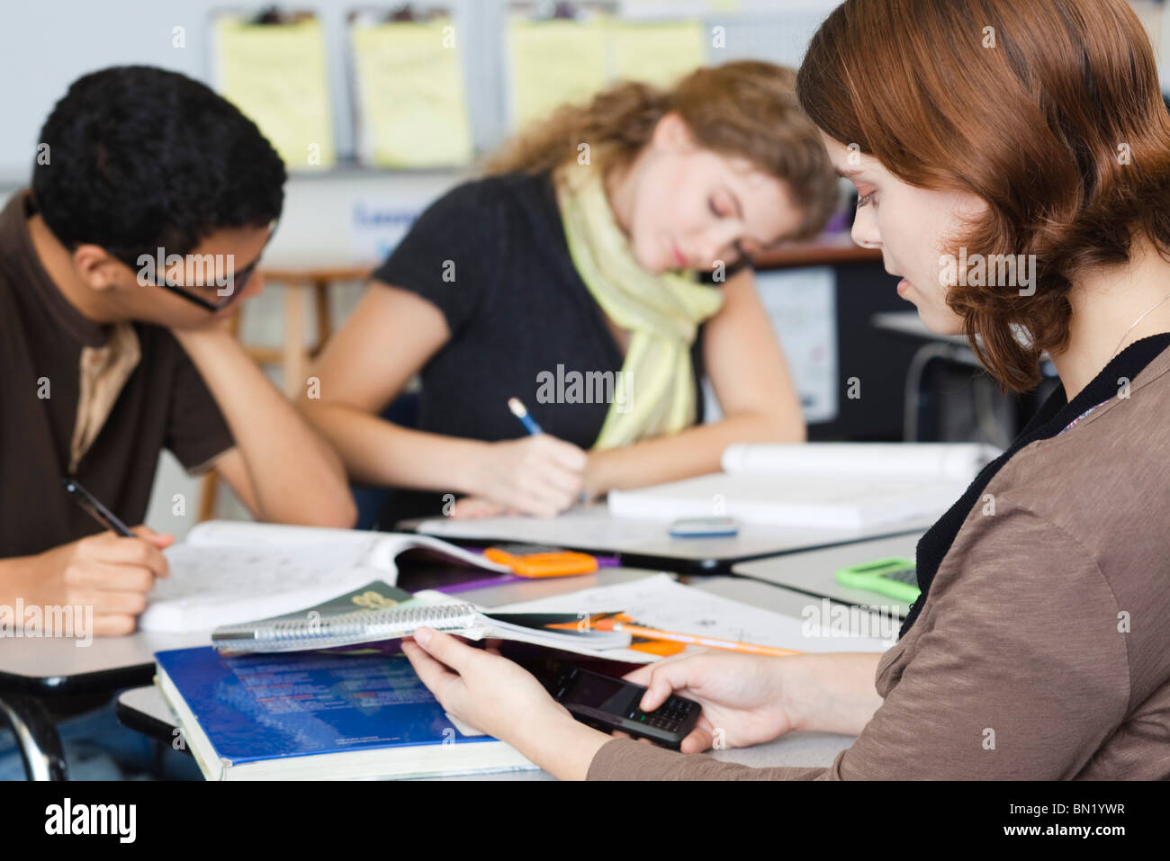 Student looking at cell phone during class Stock Photo