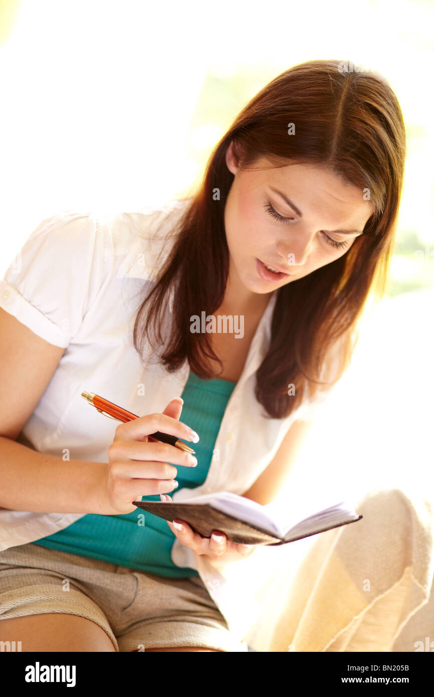 Girl looking in diary Stock Photo