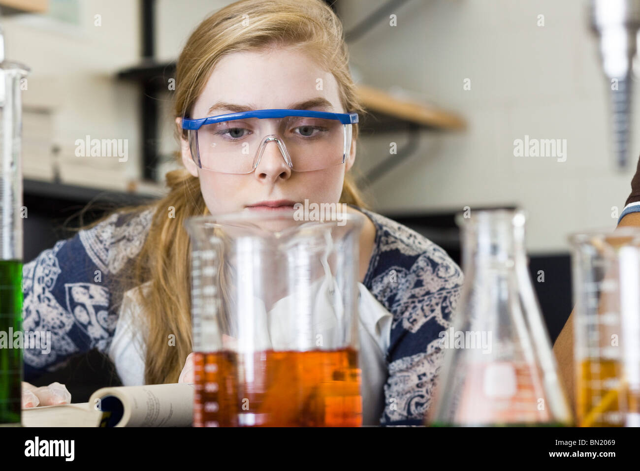 Young woman conducting experiment in chemistry lab Stock Photo Alamy