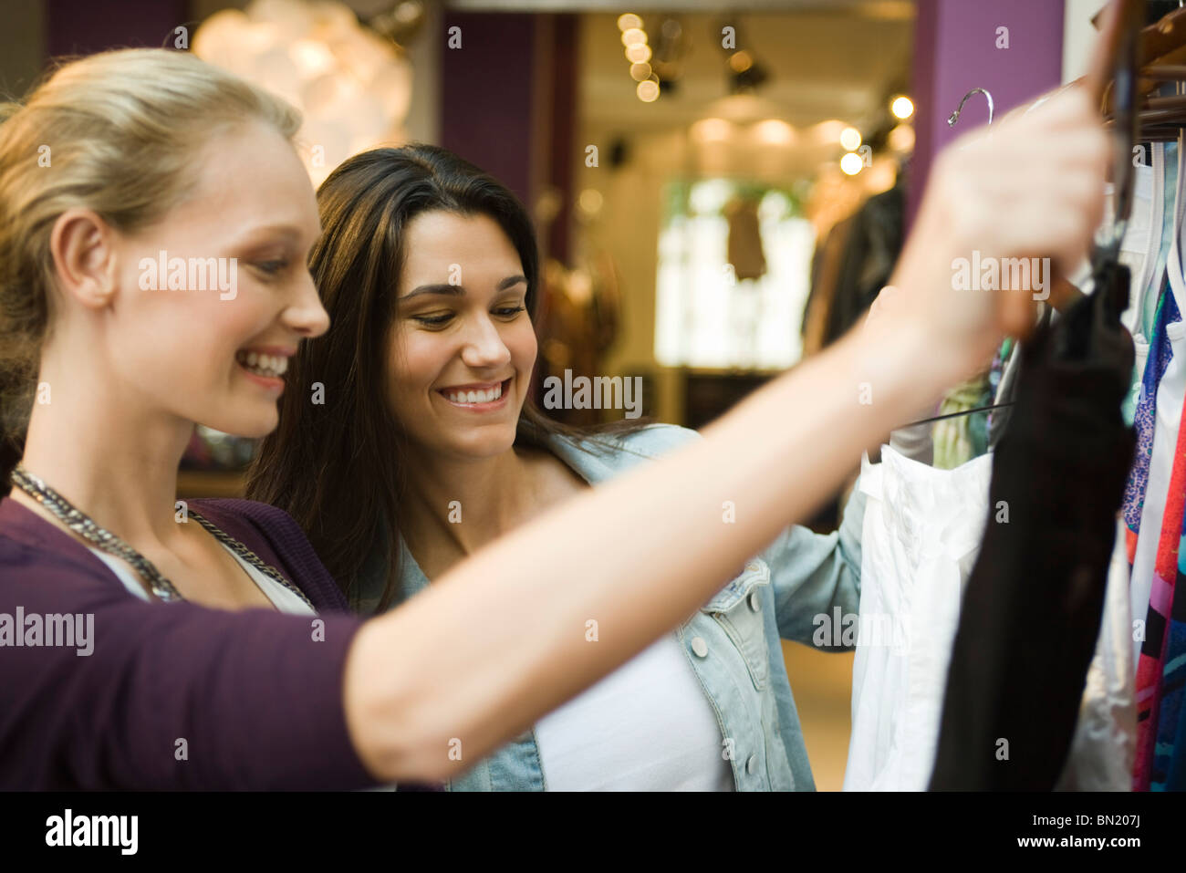 Friends shopping in clothing boutique Stock Photo