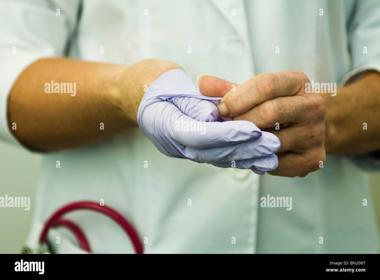 Taking off disposable latex glove Stock Photo Alamy
