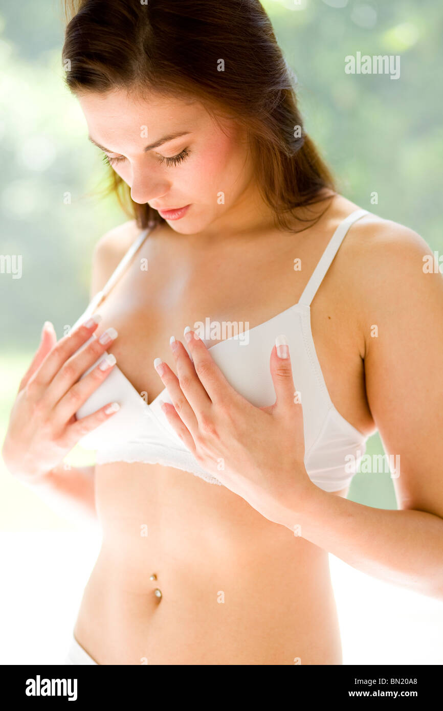 Girl holding breasts Stock Photo - Alamy