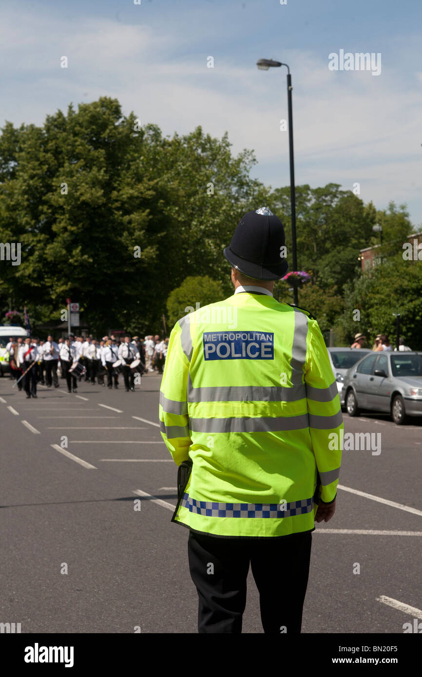 Metropolitan Police Officer in Hi-viz jacket back to camera. Stock Photo