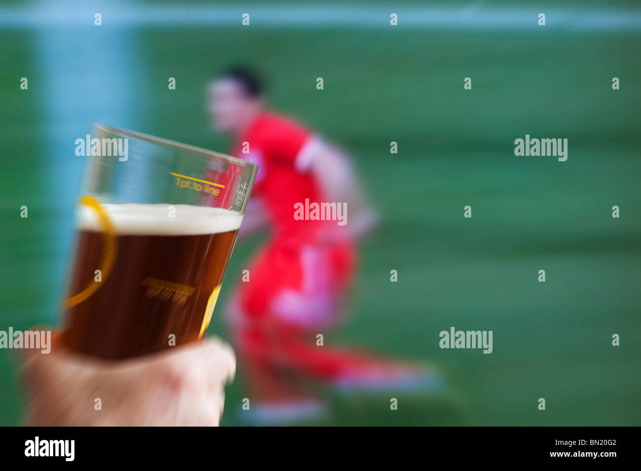 England fan watching world cup match on pub screen with pint of real ale Stock Photo