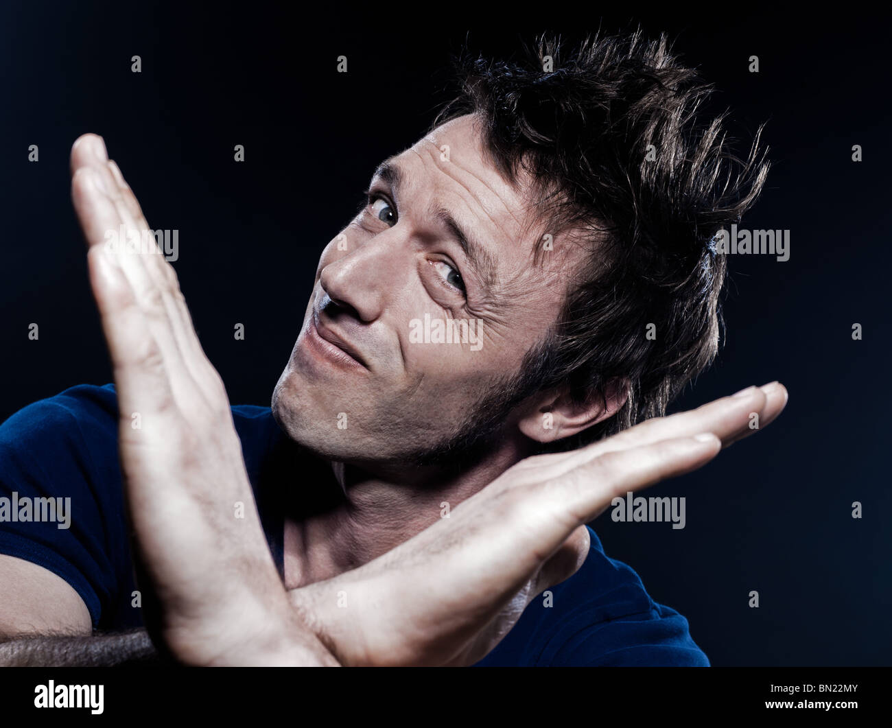 studio portrait on black background of a funny expressive caucasian man time out pause gesturing Stock Photo