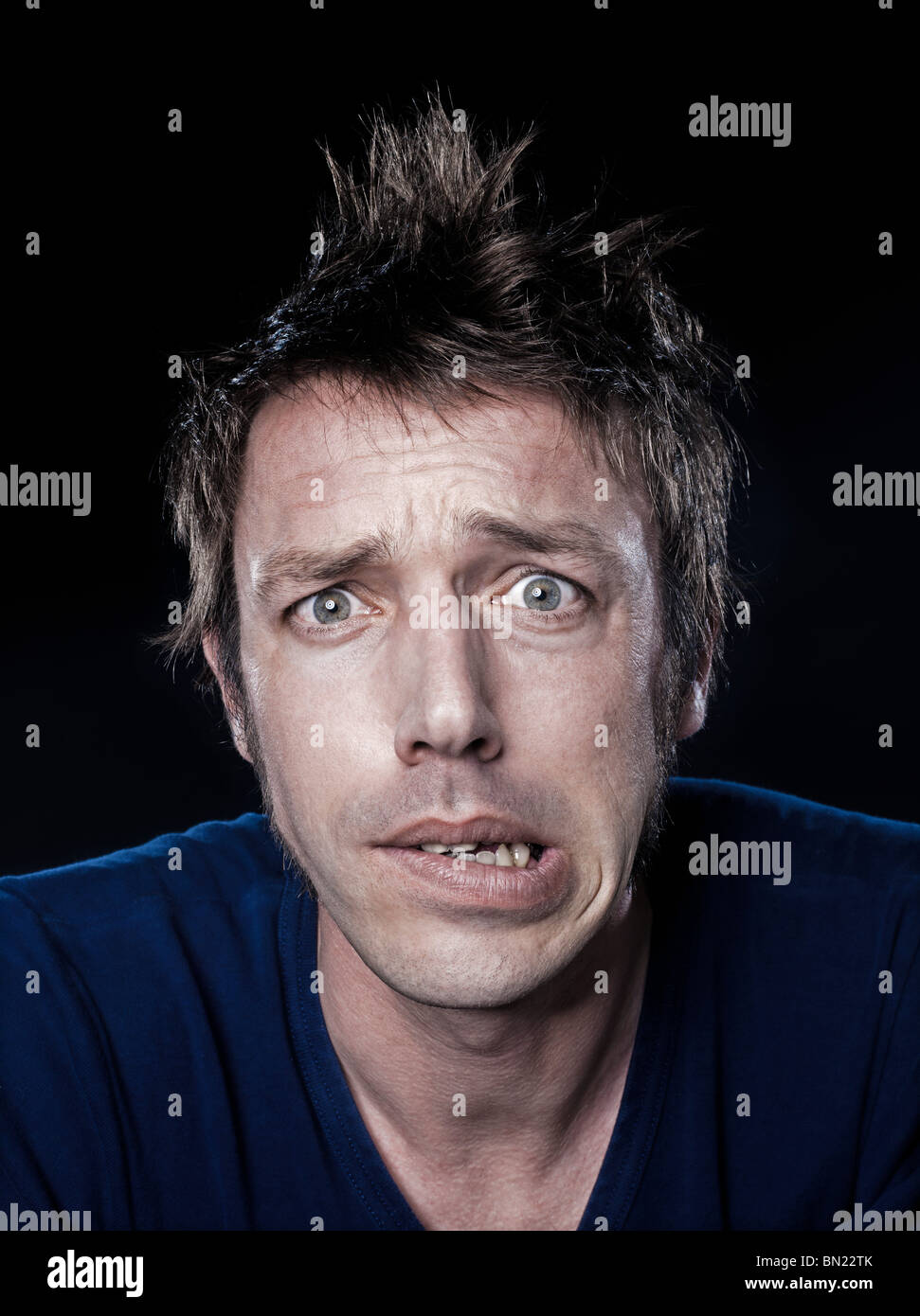 studio portrait on black background of a funny expressive caucasian man Stock Photo