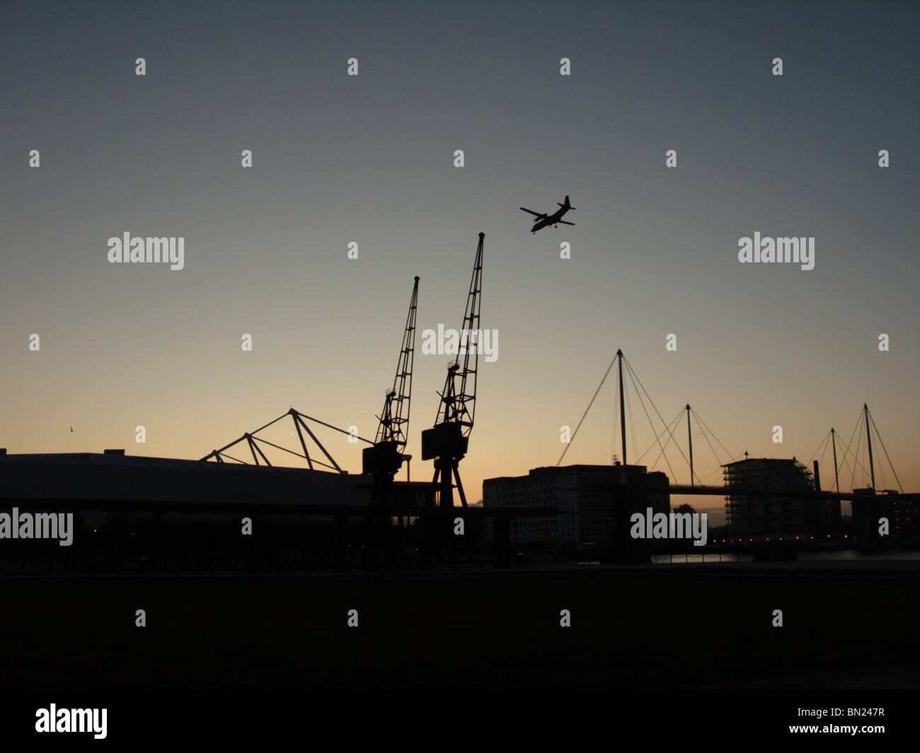 Plane landing at dusk Stock Photo