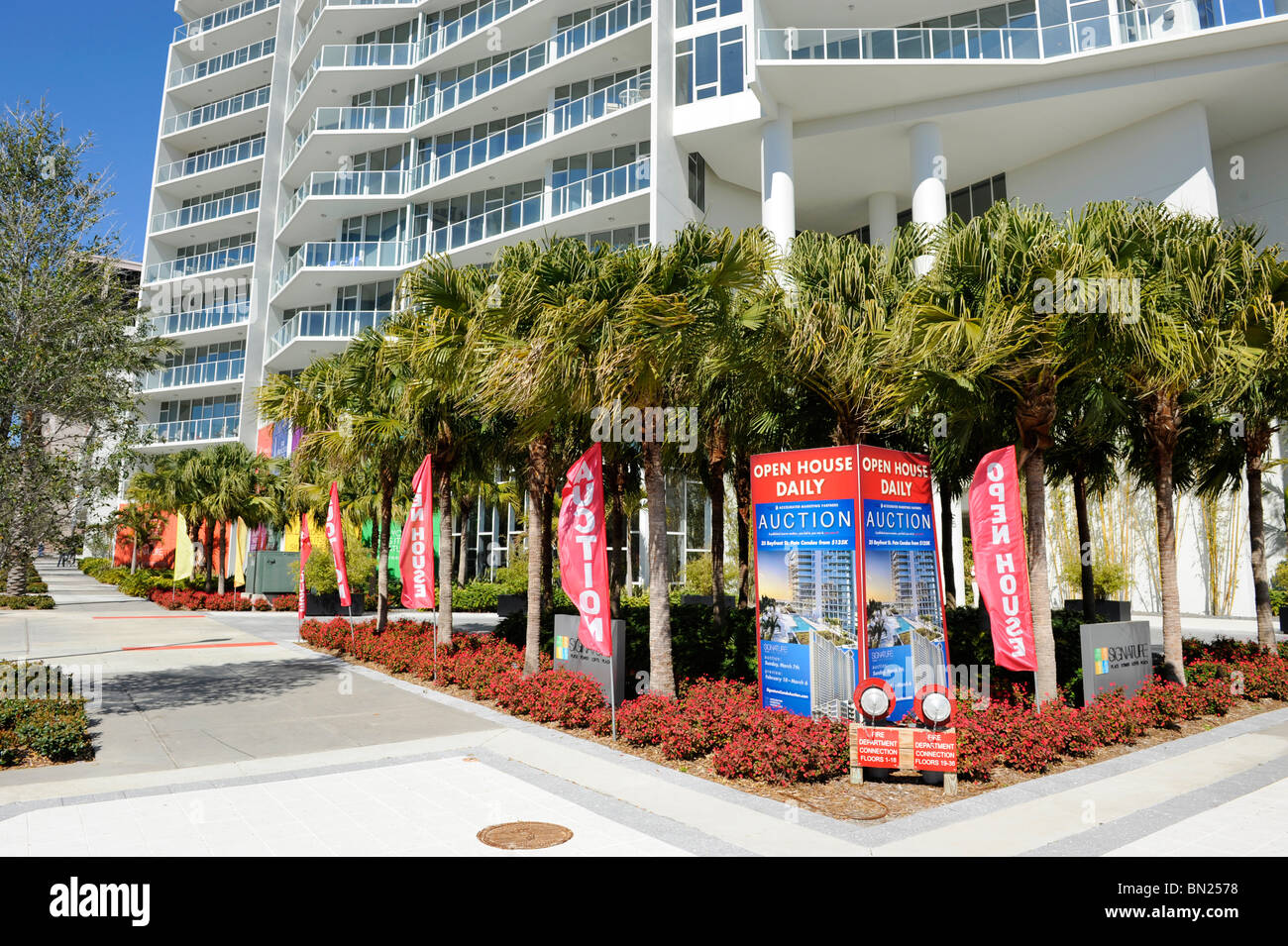 Modern condo comples in foreclosure with auction sale signs announcing auction st petersburg florida Stock Photo