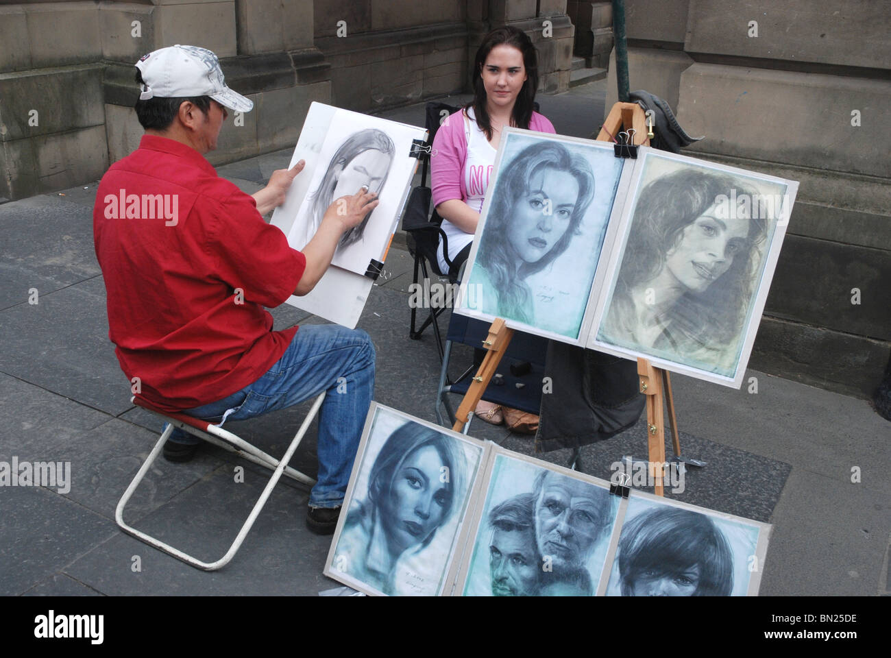 Shanice Royal and Marquita Harris the caricatures just completed by sketch  artist Ben Bloss in the milelong 16th Street pedestrian mall in downtown  Denver Colorado Marquita Harris also holds the sketch of
