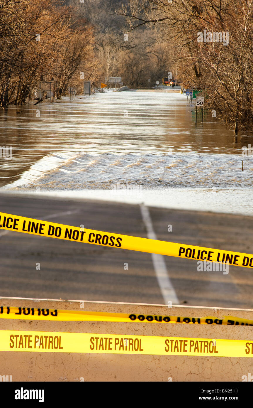Flood waters of the Minnesota River flow over highway 101 north of downtown Shakopee, Minnesota in March 2010. Stock Photo
