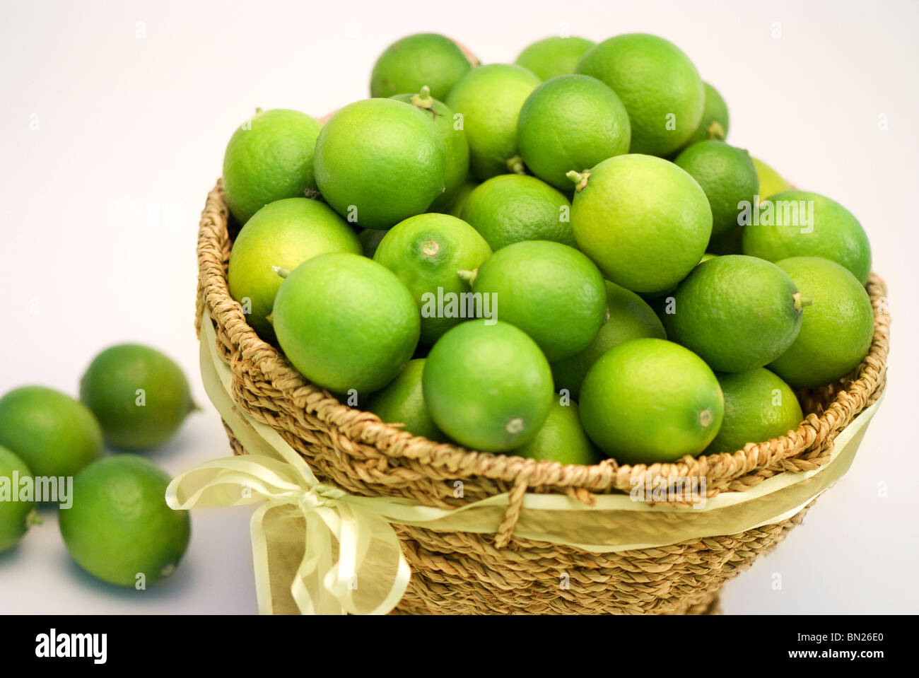 Basket of fresh, home grown limes. Stock Photo