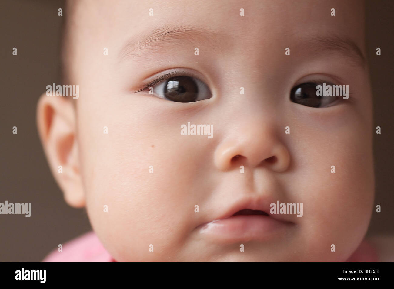 Curious Chinese baby girl Stock Photo