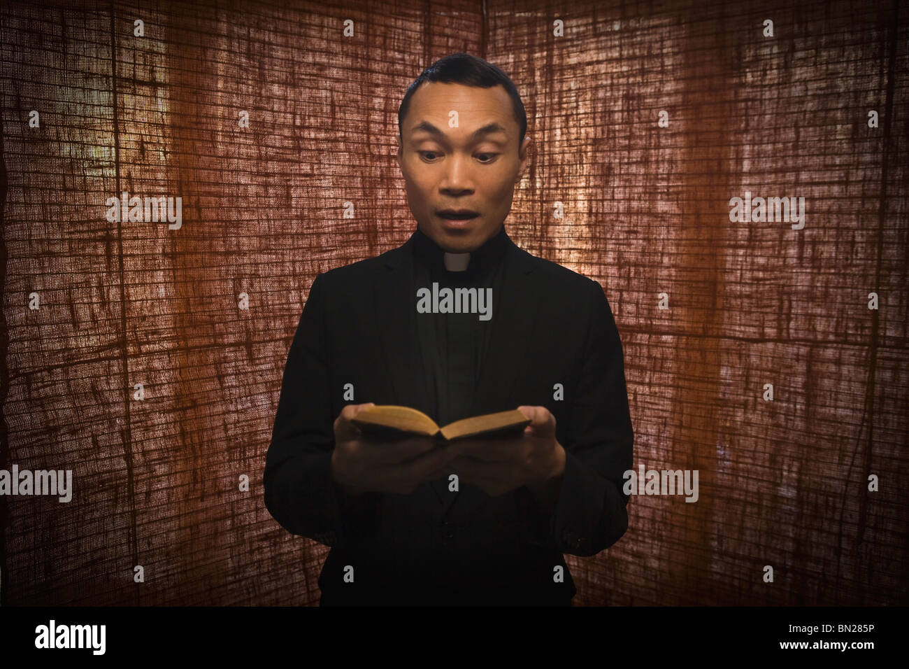 Pacific Islander priest reading bible Stock Photo