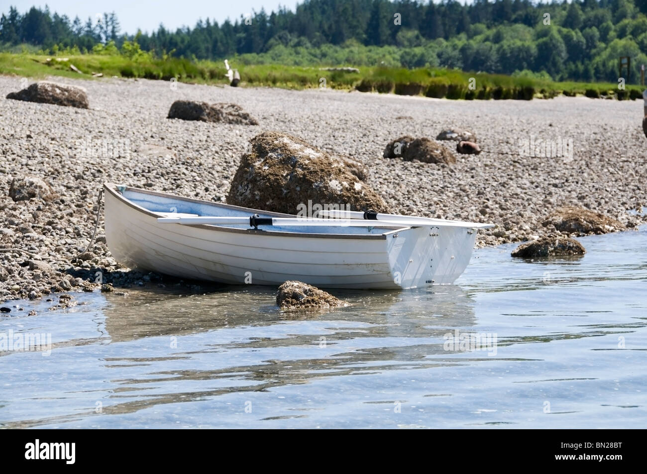 An unoccupied dinghy rests on shore at McMicken Island State Park while the owner explores the