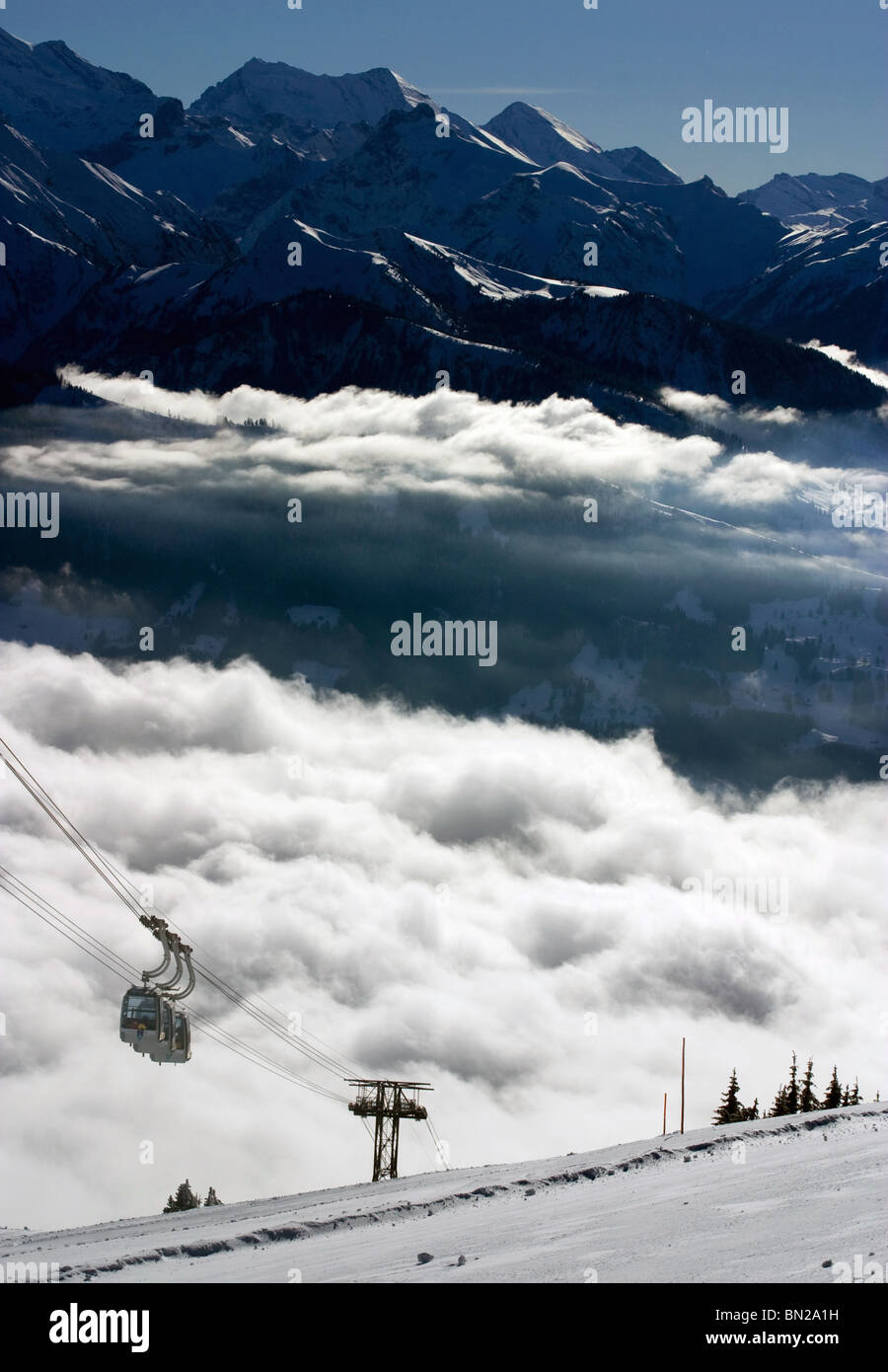 Swiss alps aerial Aerial cable cars rising up through the clouds
