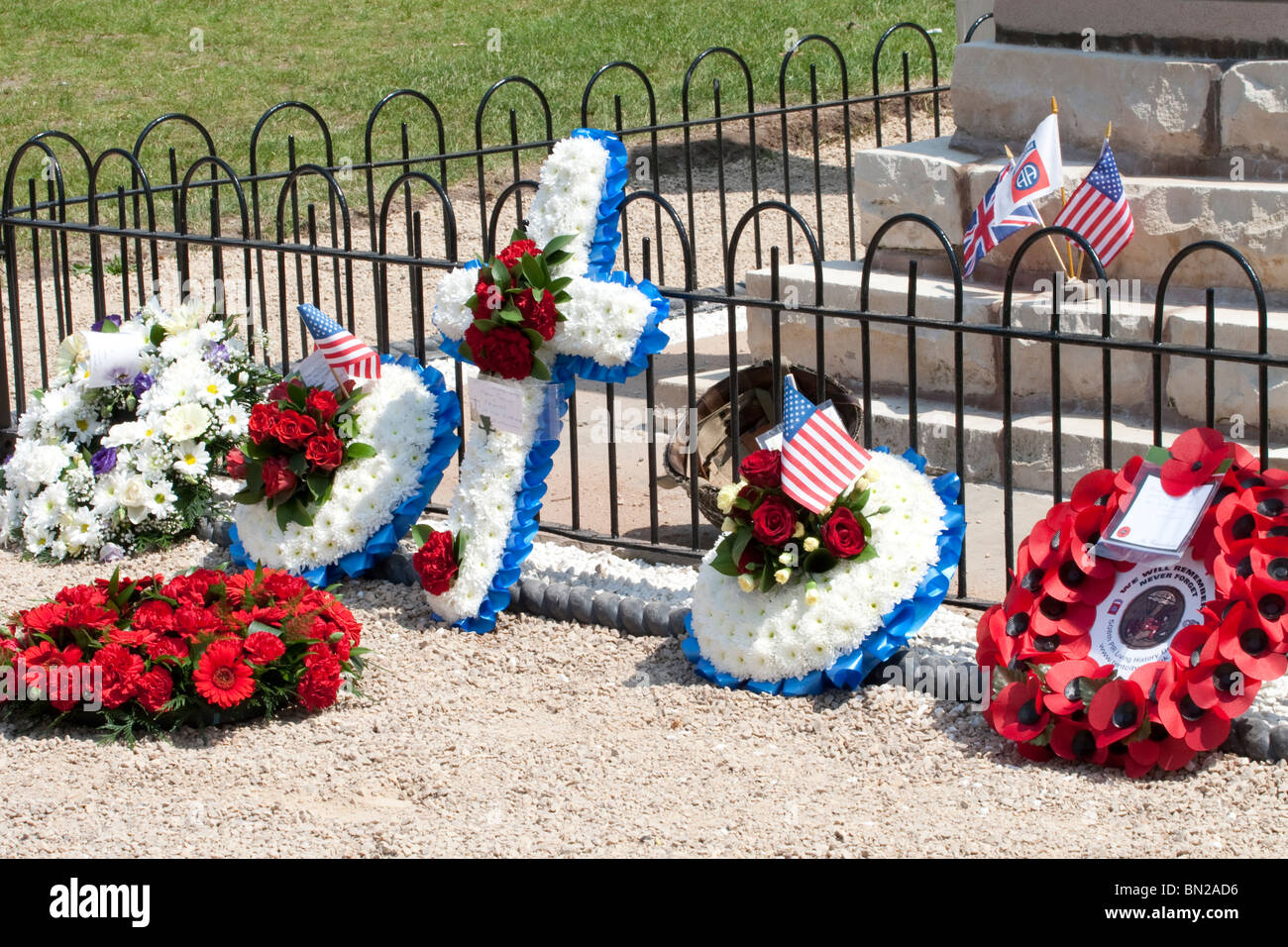 Poppies, reefs and flowers laid in front of a war memorial in tribute ...