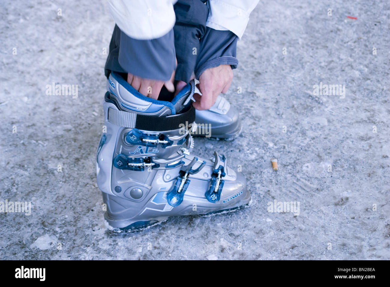 Woman putting ski boots on Stock Photo