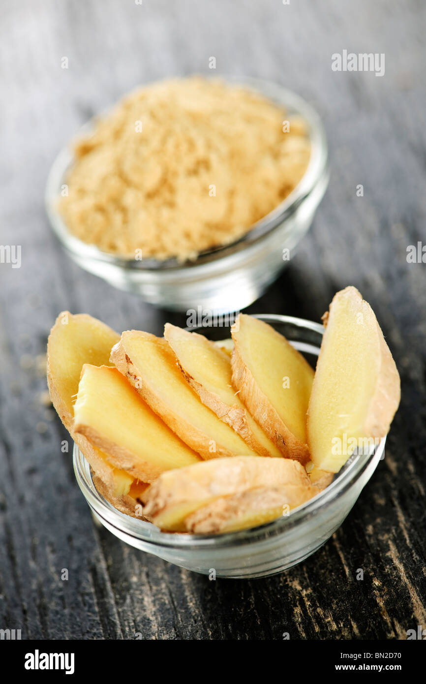 Sliced and ground fresh ginger root spice in glass bowls Stock Photo