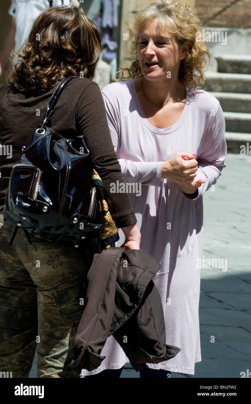 Two women in conversation, Siena, Tuscany Stock Photo