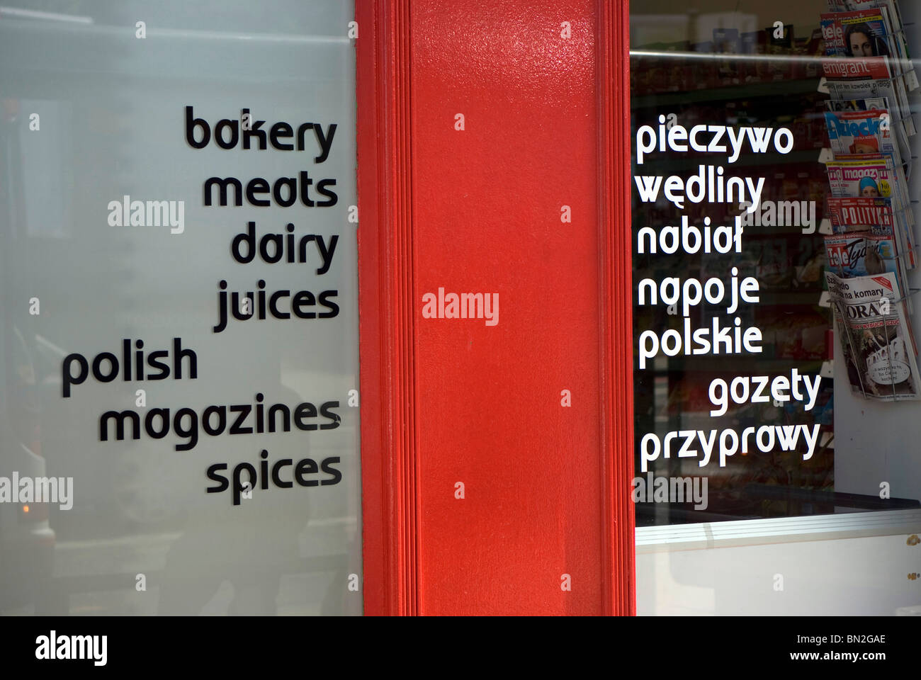 Windows of a Polish corner shop in Edinburgh, Scotland, advertising its products in English and Polish. Stock Photo