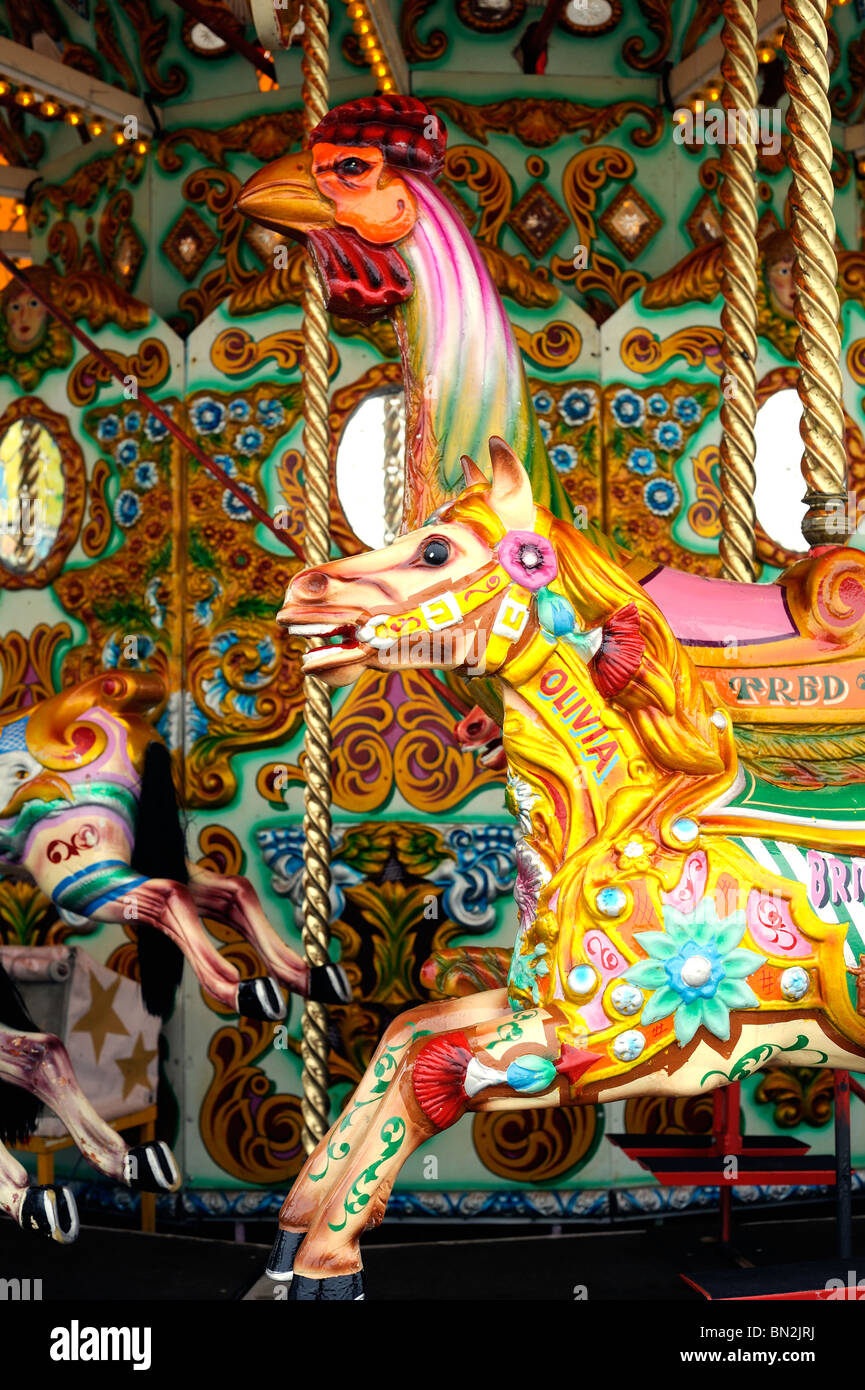 Colourfully painted horse and bird on a fairground carousel Stock Photo