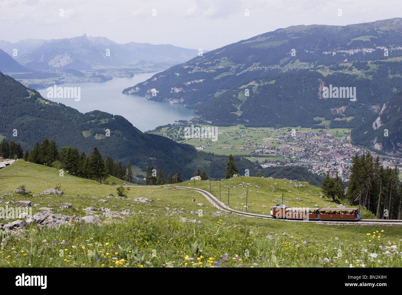 Swiss Alps Aerial: Cog train from Schynige plate Bahn and view on Interlaken and Thunersee (lake Thun) Stock Photo