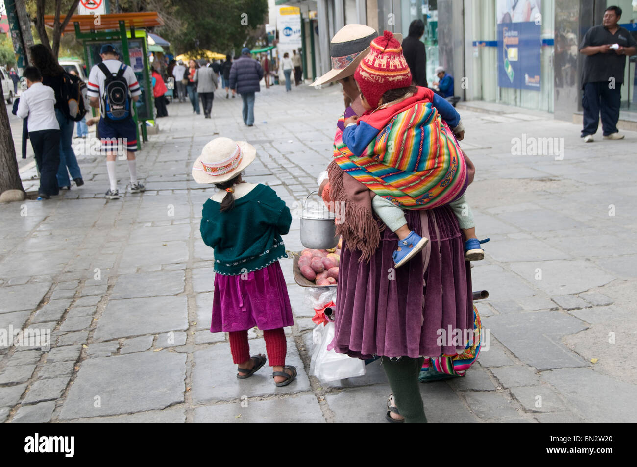 Magical Andes Photography  Aymara woman shopping at stall selling red and  yellow underwear on New Year's Eve, La Paz, Bolivia photograph