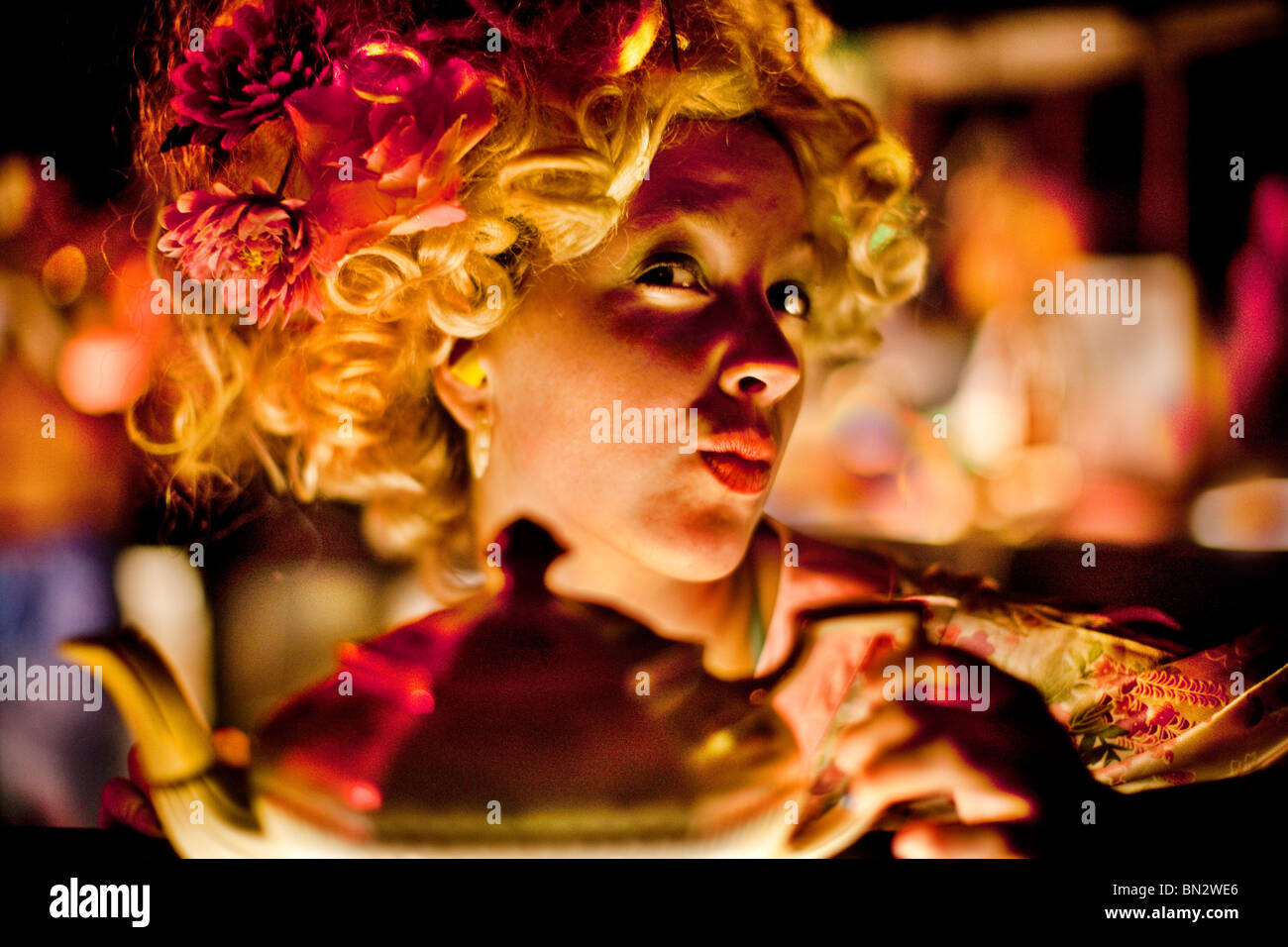 a woman wearing fancy dress and holding teapot Stock Photo Alamy