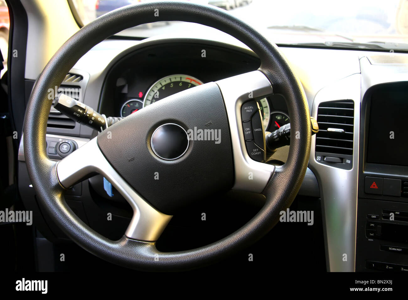 Steering wheel and dashboard of a vehicle interior Stock Photo