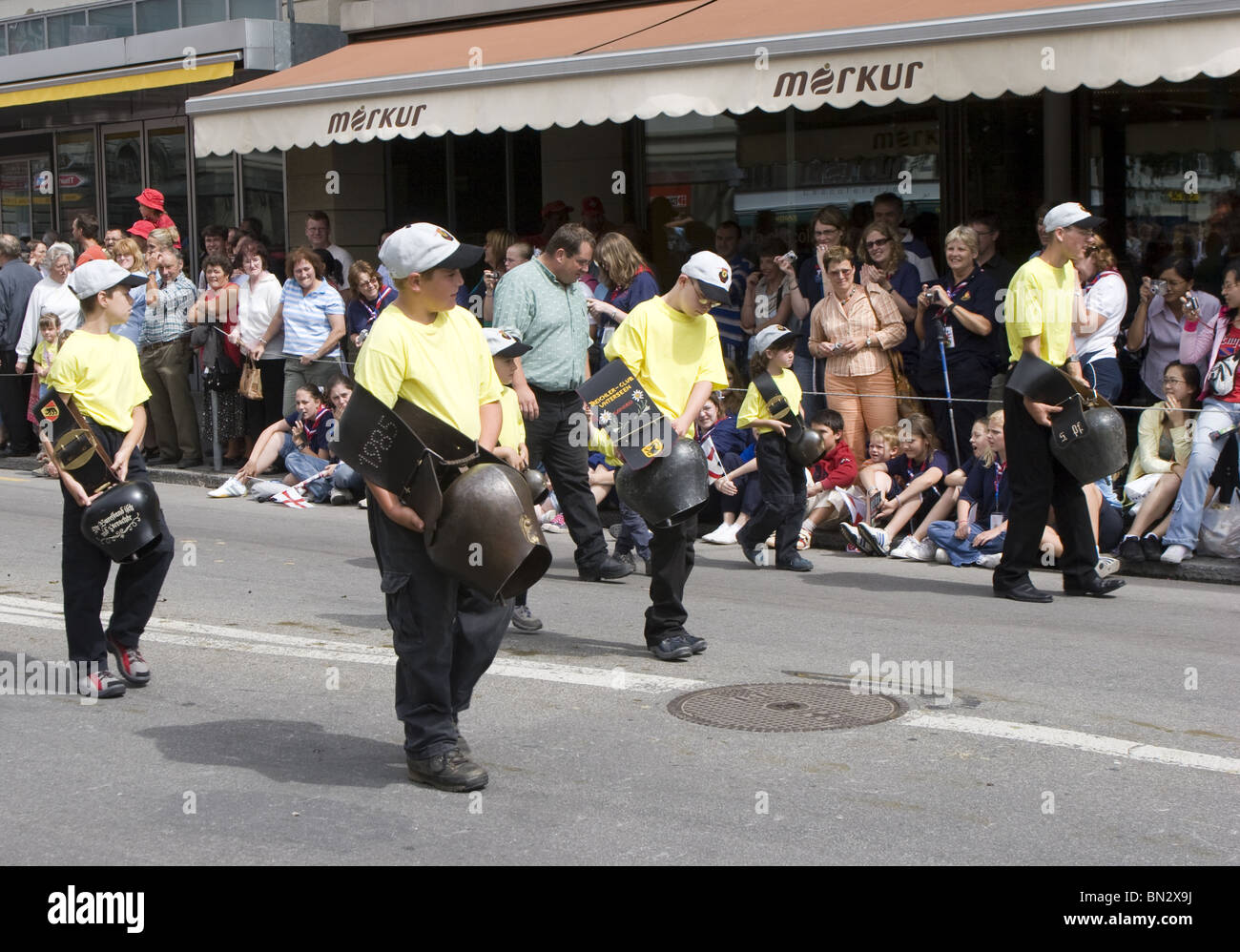 Nostalgic iAlpine bell ringers clinging huge cow bells on swiss parade at Swiss National Holiday due to Swiss festival Stock Photo