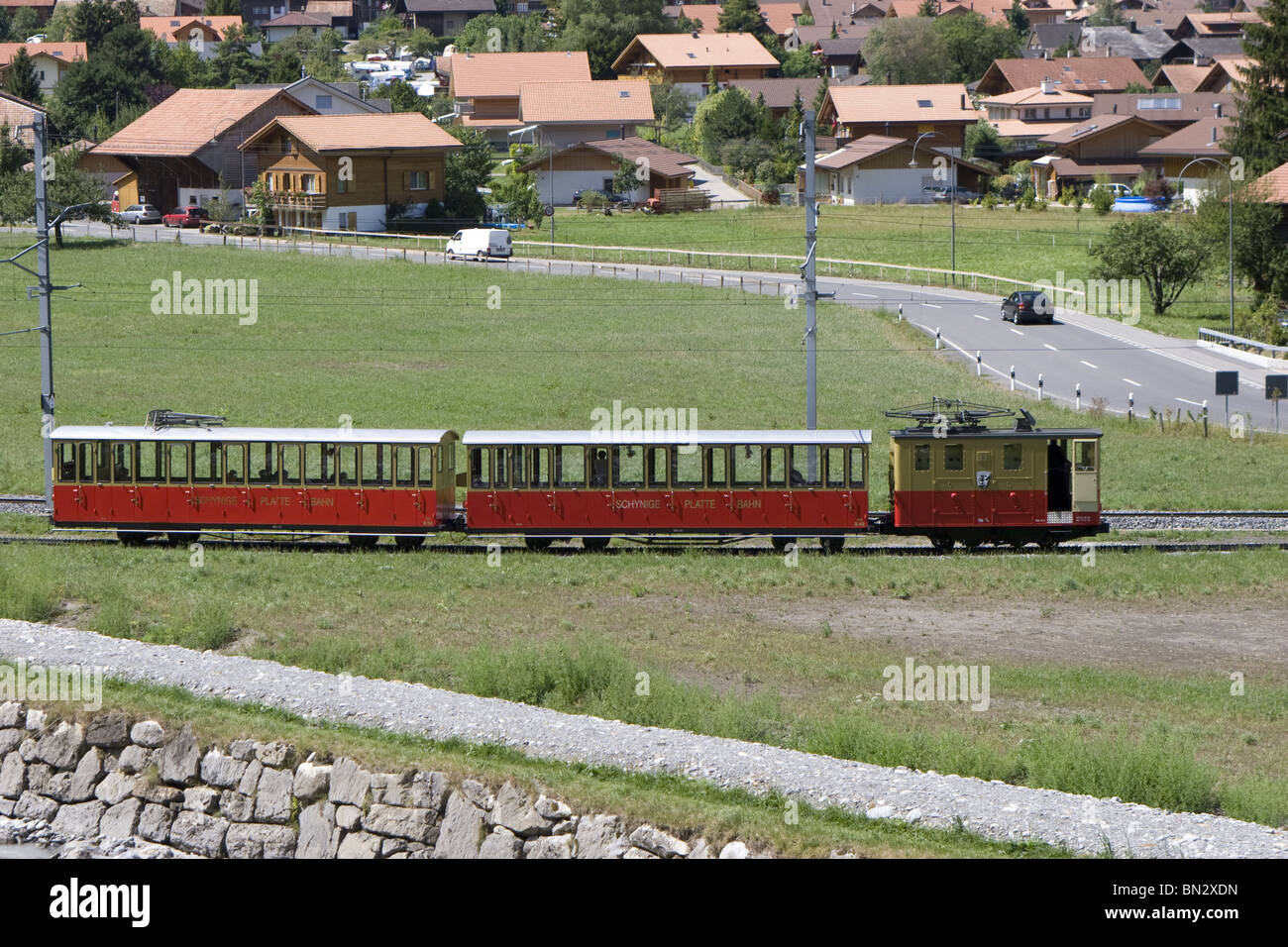 Swiss mountain train: Schynige platte train railway to alp garden Village of Wilderswil in background train heading to station Stock Photo