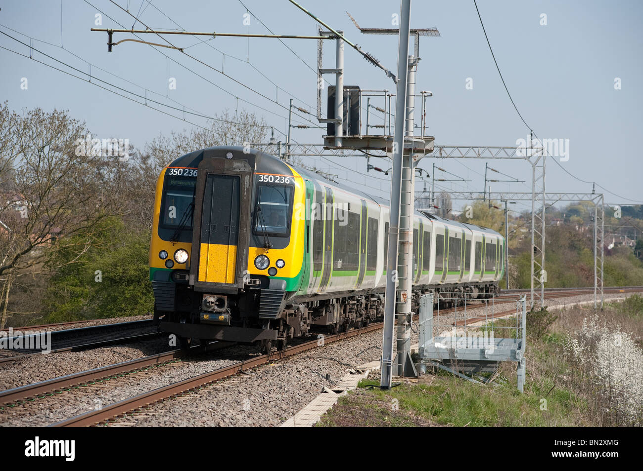 London Midland trains passenger train class 350 travelling at speed through the english countryside. Stock Photo