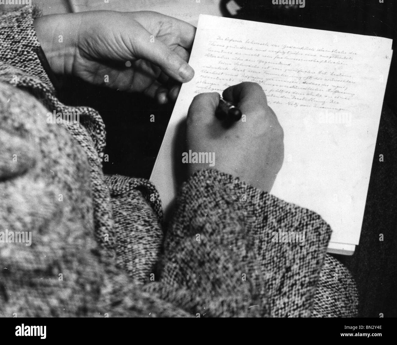 ALBERT EINSTEIN (1879-1955) German-born theoretical physicist writing a paper in German at his Princeton home in 1940 Stock Photo