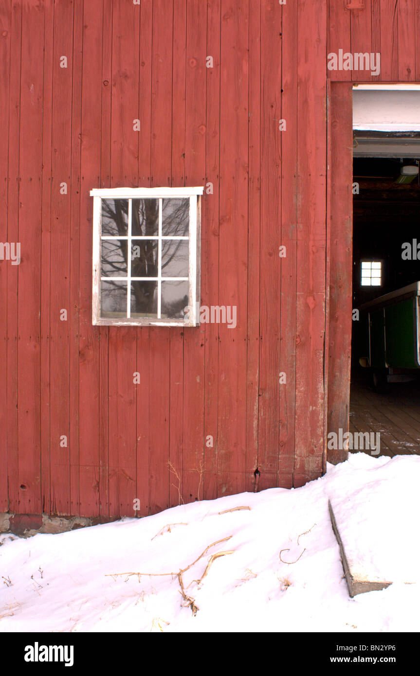 Red barn with window in the snow Stock Photo - Alamy