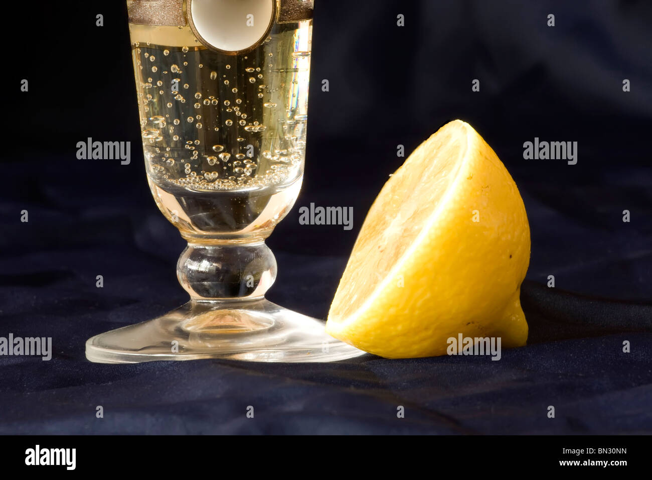 Italian aperitif with lemon on blue silk Stock Photo