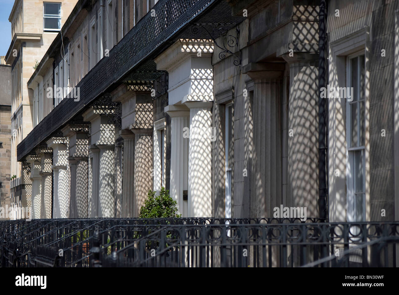 Shadows on the pillars of a row of buildings in the centre of Edinburgh